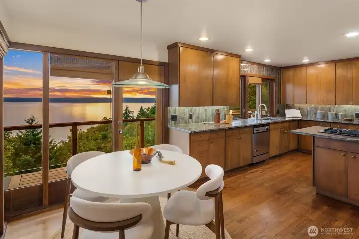 Dining room features a new door that leads out to the main level deck.