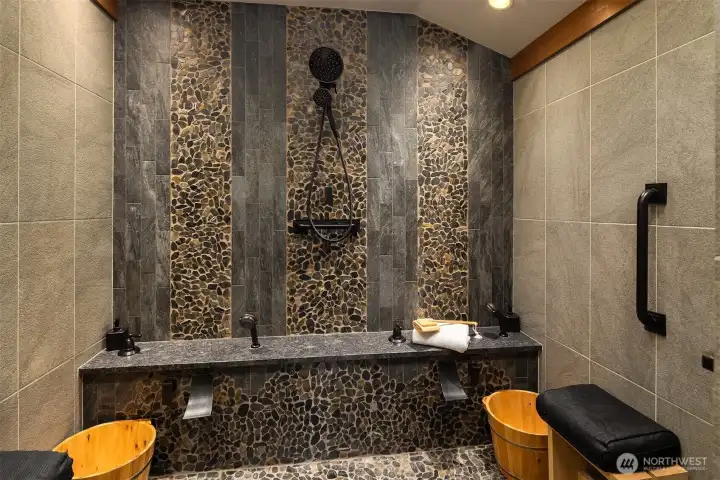 Japanese style shower with a skylight, ceramic tile and river rock.