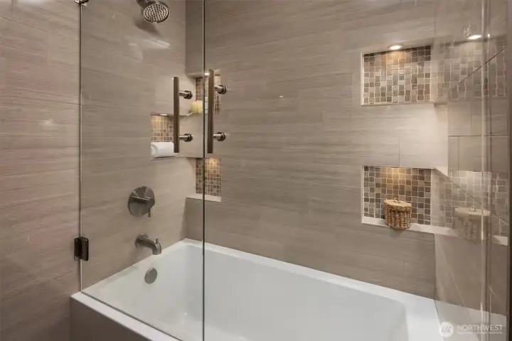 Main level full bath was remodeled with a floating glass door, ceramic tile and a new modern tub.