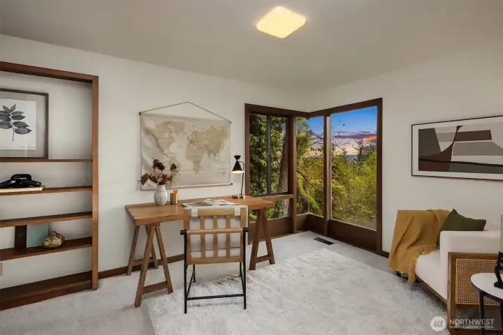 Bedroom on the main features new carpet, floor-to-ceiling windows that look out to a view.
