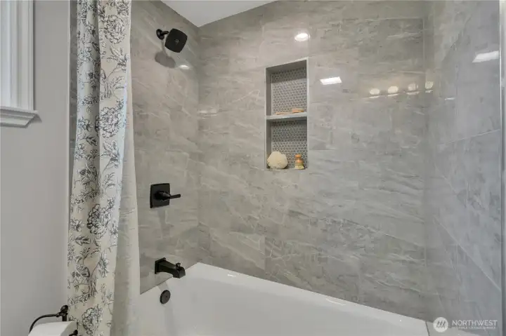 Simple, elegant cast iron tub and shower with clean lines.  It's just right for this home.