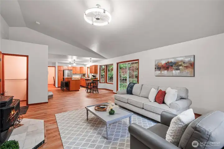 Beautiful open concept living with new LVP flooring and updated lighting,  perfect for entertaining or just enjoying your evenings at home.