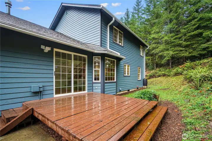 Deck off of slider door surrounded by mature trees makes entertaining easy!
