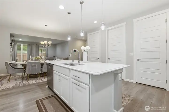 Luxurious kitchen with quartz counters, a huge walk-in pantry, upgraded cabinets and tons of storage