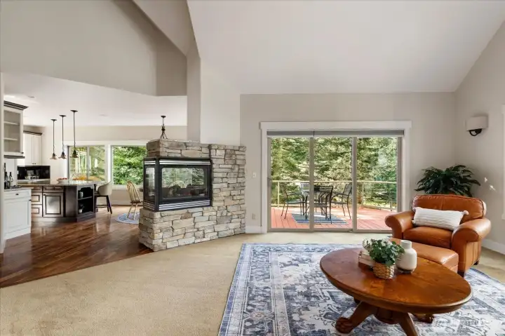 Views from the living room looking towards the kitchen with a central propane fireplace.