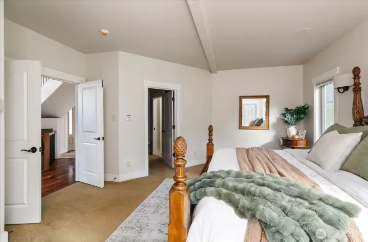 Views from the primary bedroom looking towards the walk through closet that leads to the primary full bathroom.