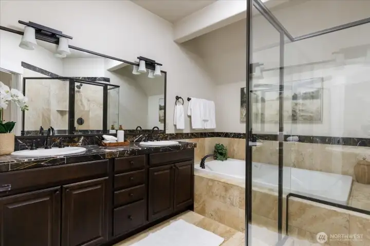 Gorgeous marble full bathroom with deep soaking tub and oversized shower.
