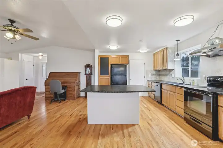 Kitchen with view of the garage entrance on the right of the fridge.