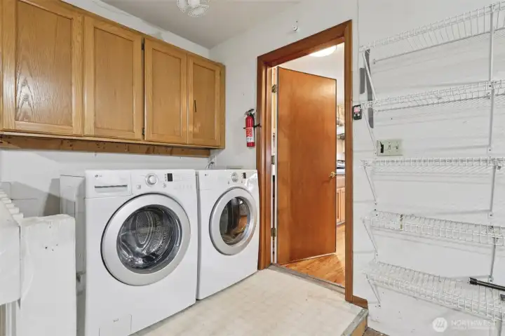 Laundry and utility room located within the garage. The door leads to the kitchen.