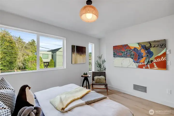 The articulation of diverse window geometries enhances spatial character, channeling abundant light while maintaining controlled privacy.