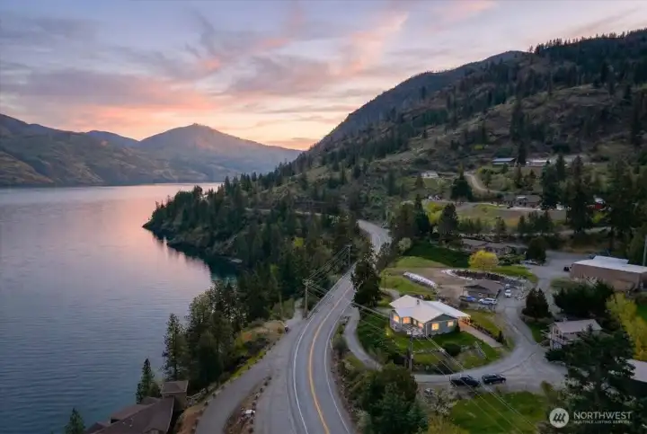 Twilight drone photo of home and lake