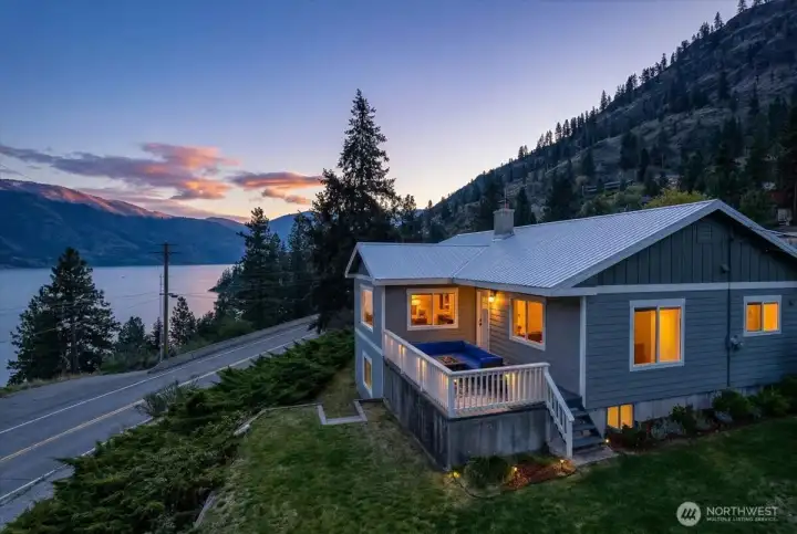 Twilight drone photo of home and lake