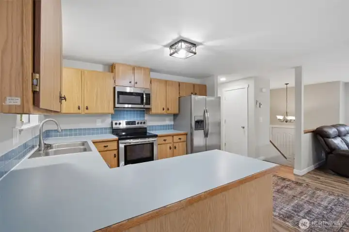 Just off the living room is the spacious kitchen, w/ a large peninsula to use as a serving area or extra counter space.