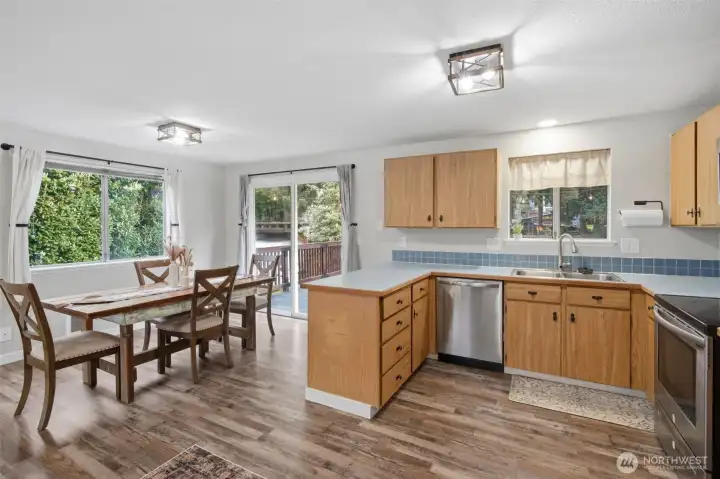 A view of the open space concept to see how easily it is to serve meals from the kitchen to the dining area. And look at all the natural light from these oversized windows!
