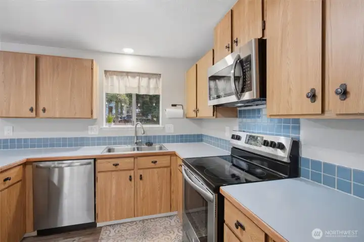 Another view of the spacious kitchen with stainless steel appliances.