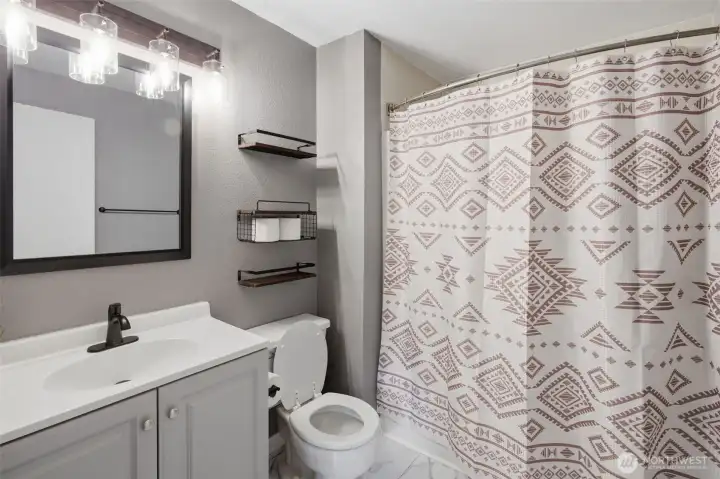 Here is a great view of the primary bathroom, that is completely updated. New vanity, flooring, lighting and so much more!