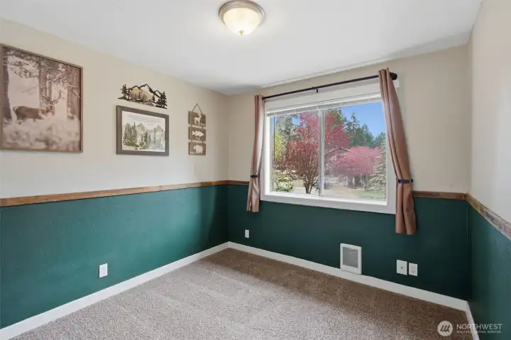 Photo of bedroom #3, also just a crossed the hall from the primary bedroom and next to to bedroom #2. Nice and convenient to keep everyone near each other.