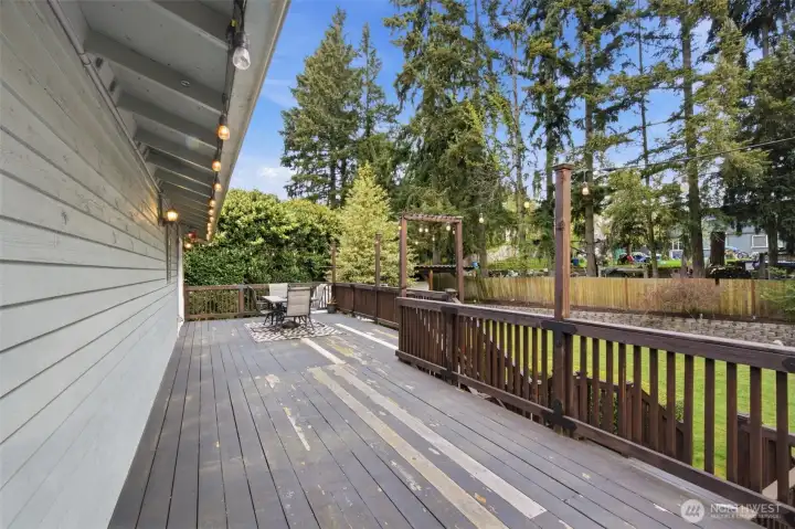 View of large upper floor deck. This deck has plenty of space of entertaining or back yard BBQ's. Seller has repaired lose or broken boards, as you can see in this photo.