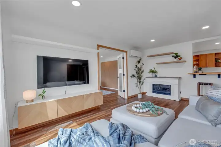 living room and kitchen with bonus room doorway