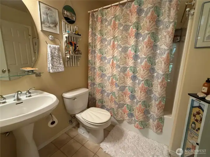 3rd bathroom with tub has two doors, one leads to 3rd bedroom and the other is accessed from loft area.