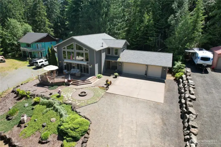 Enjoy cozy firepit, water feature that conveys with property, motorized awning and much more!