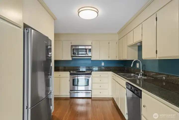 To the left of the fridge is a large pantry with pull out shelves.