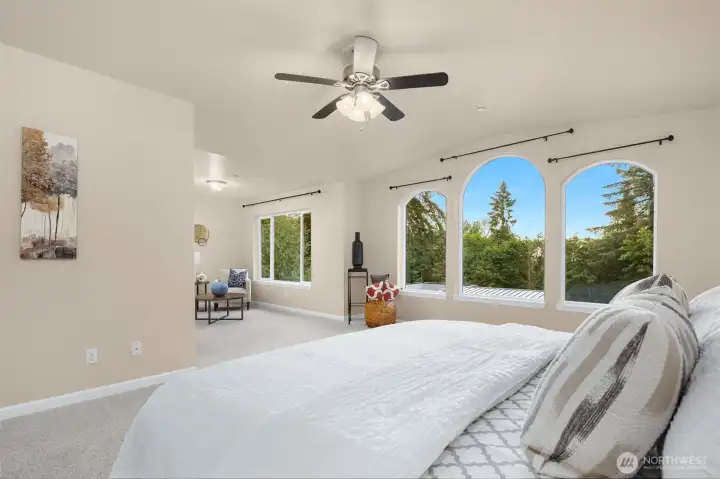 Primary suite with large sitting area, attached 5-piece bath, walk-in closet & private patio.