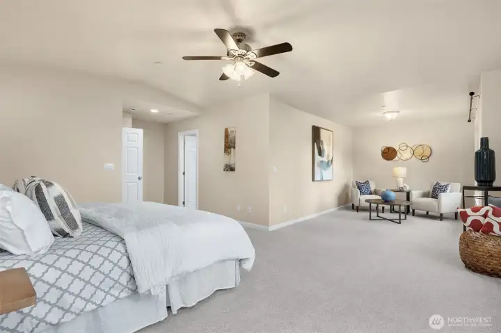 Primary suite with large sitting area, attached 5-piece bath, walk-in closet & private patio.
