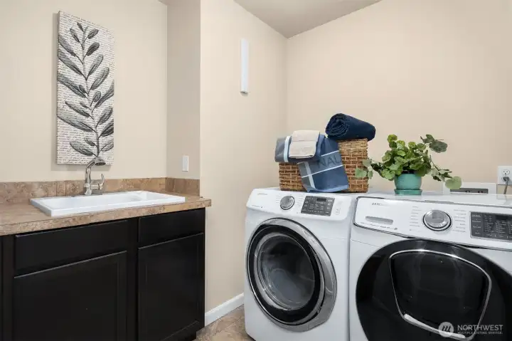 Upstairs laundry room with utility sink.