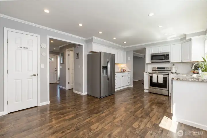 Generous kitchen includes a convenient pantry and crisp white cabinetry Generous kitchen includes a convenient pantry and crisp white cabinetry