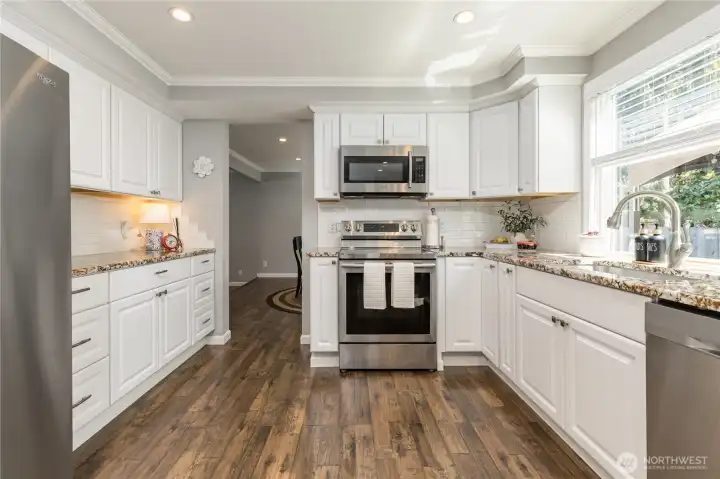 Elegantly updated with granite counters, stainless appliances and a classic white tile backsplash Elegantly updated with granite counters, stainless appliances and a classic white tile backsplash