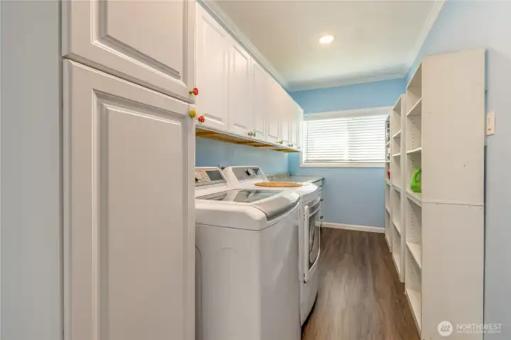 Laundry/mudroom between the kitchen and garage offers exceptional storage Laundry/mudroom between the kitchen and garage offers exceptional storage