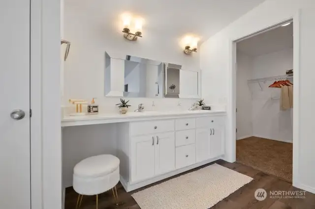 PRIMARY BATHROOM WITH DOUBLE VANITIES AND MAKE UP AREA WITH DOUBLE WALK IN CLOSETS AND ADDITIONAL STORAGE