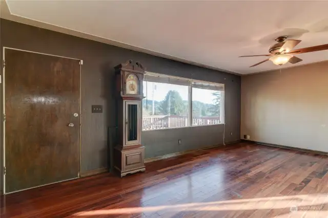 Living room with large windows allowing abundant natural light to flow through.