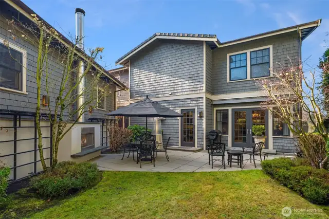 Side yard with outdoor fireplace and patio adds charm. Have a seat by the fire