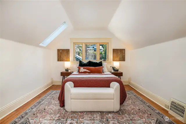 Larger bedroom on the upper level with great ceiling height, new window, and a skylight