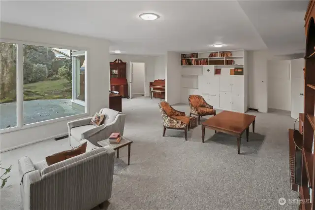 Daylight basement with rec room, bedroom, bathroom, and large storage room.