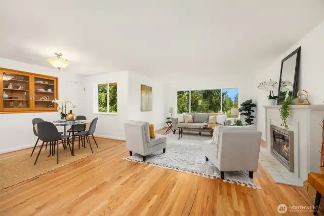Main level spacious living and dining rooms with gleaming oak hardwood and a cozy gas fireplace