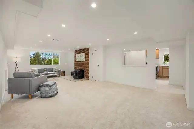 Lower level family room with wood burning fireplace stove