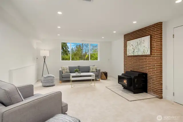 Lower level family room with wood burning fireplace stove