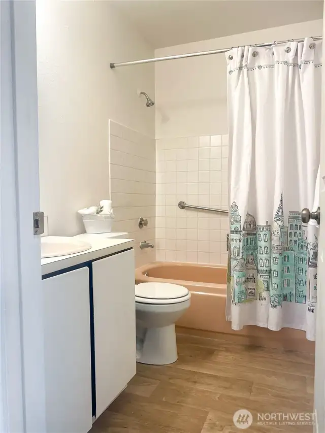 Hallway bathroom with new vent and grouting.