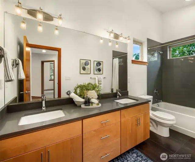 Shared bath for bedroom 1 and bedroom 2 with double vanity.