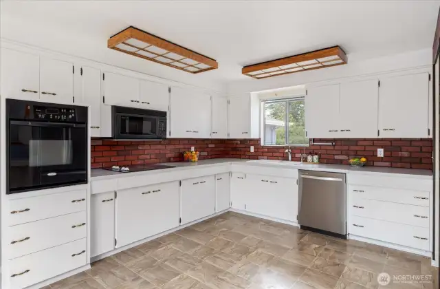 Step into this great kitchen! With loads of prep space and storage, you're going to love cooking here!