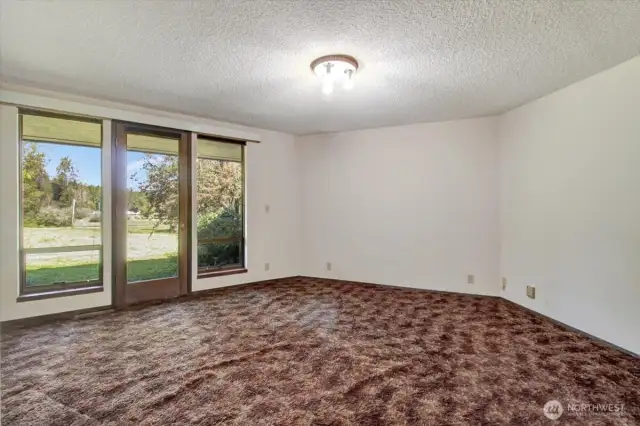 The primary bedroom #1 is large. In this image, you can observe the door leading to the exterior.