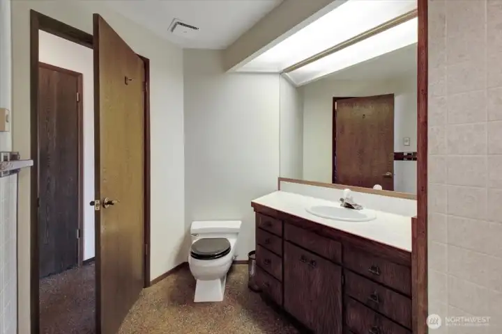 Bedroom #3 features a full en-suite bathroom that includes an additional exit to the hallway.