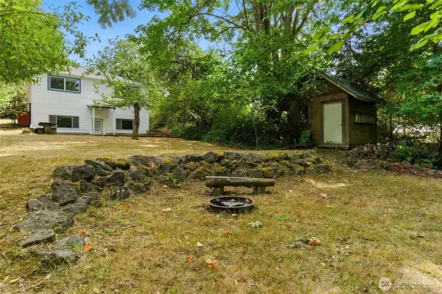 Quaint shed in back yard plus a firepit!