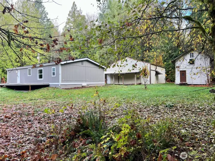 Creekside of property view - house on left, garage in middle, man cave on right!