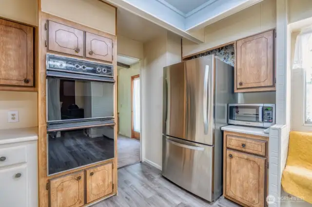 Double ovens, SS fridge, dishwasher and NEW flooring.