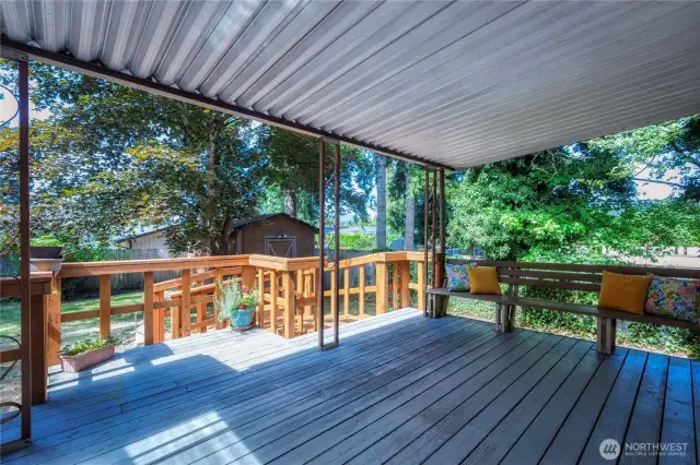 Generous sized covered back deck ~ perfect for lounging or hosting gatherings any time of year.
