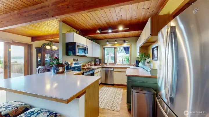 Bright kitchen with new stainless steel appliances and breakfast bar.